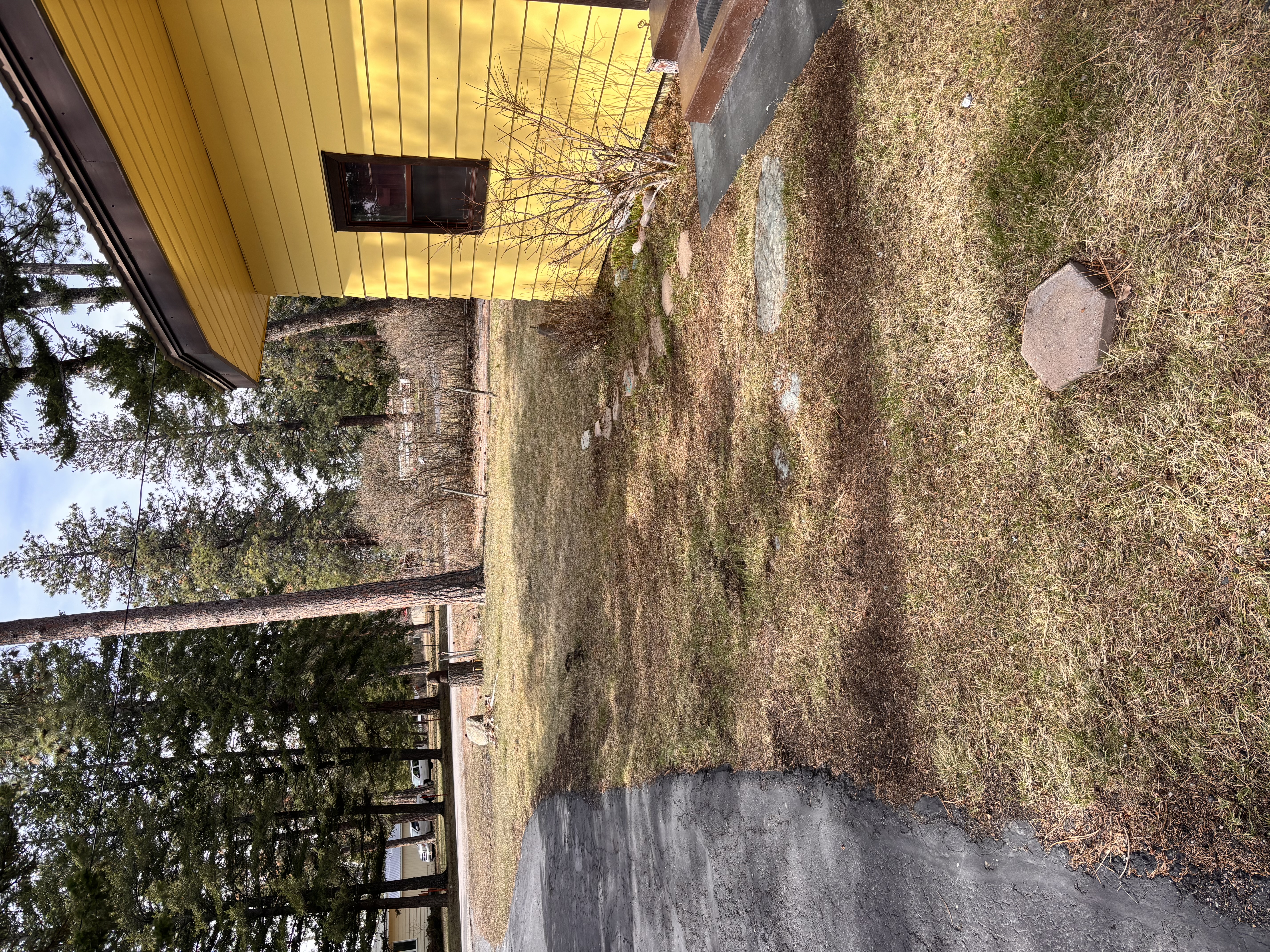 Spring cleanup after — yellow house front